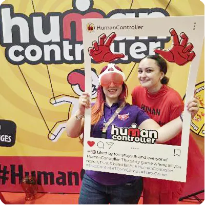 Controller and human both holding a 'Human Controller' sign
